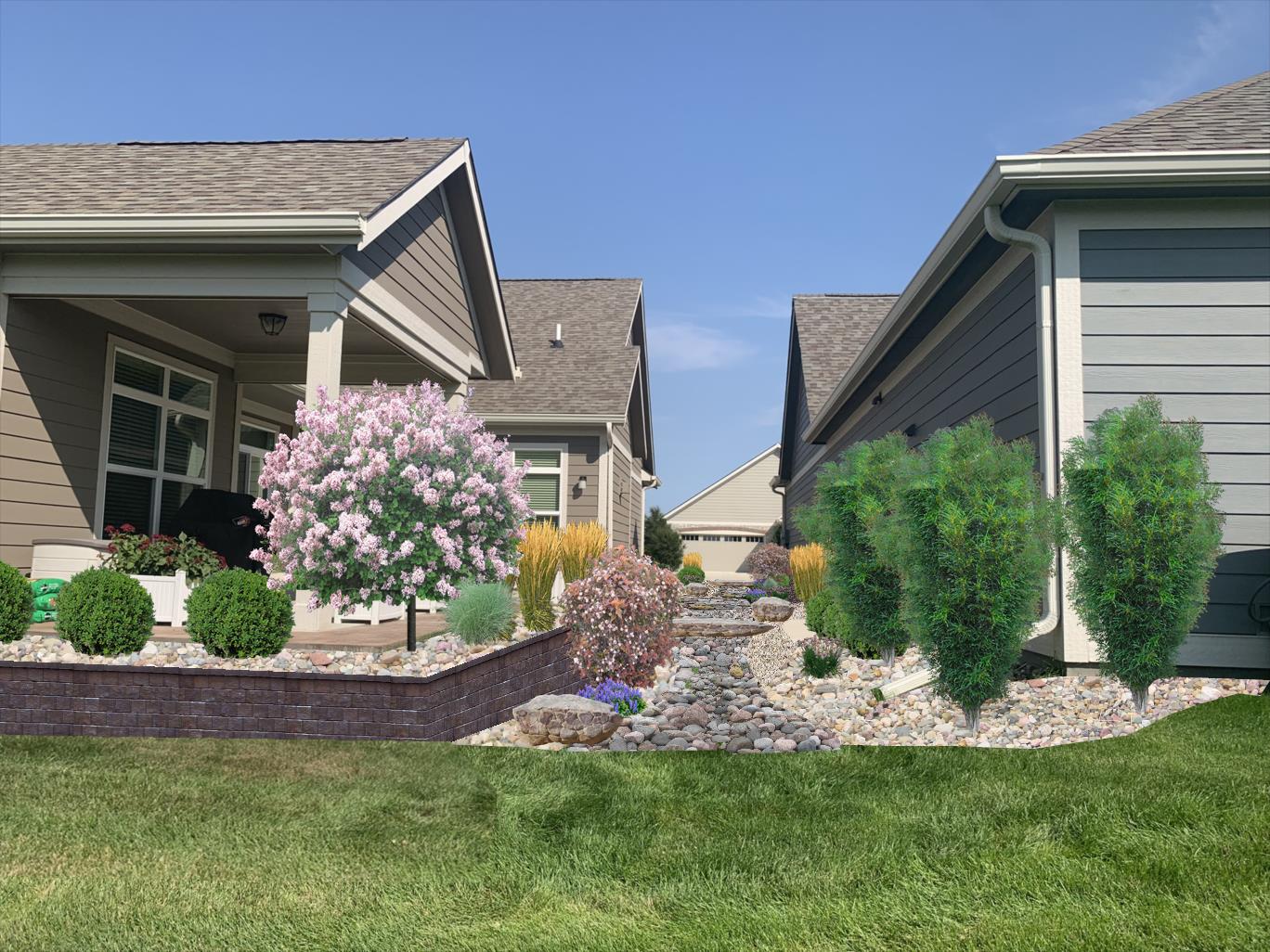 Residential landscaping with flowering shrubs, ornamental grasses, and stone pathway between two houses, showcasing design elements for homeowners.
